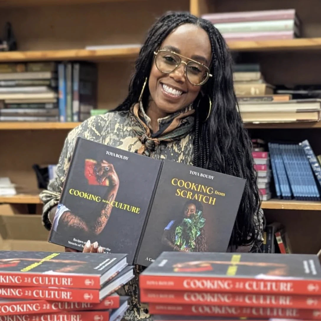 Toya Boudy holding her cookbooks